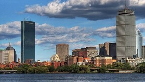A city skyline with various buildings, including a tall skyscraper and a shorter building with a dome. - Boston Apartment | near T (Boston)