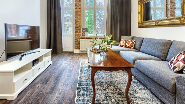 A living room with a television, sofa, and coffee table.