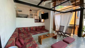 Basic Villa | Living area | 50-inch Smart TV with satellite channels