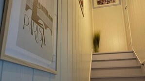 A staircase with a framed sign on the wall.