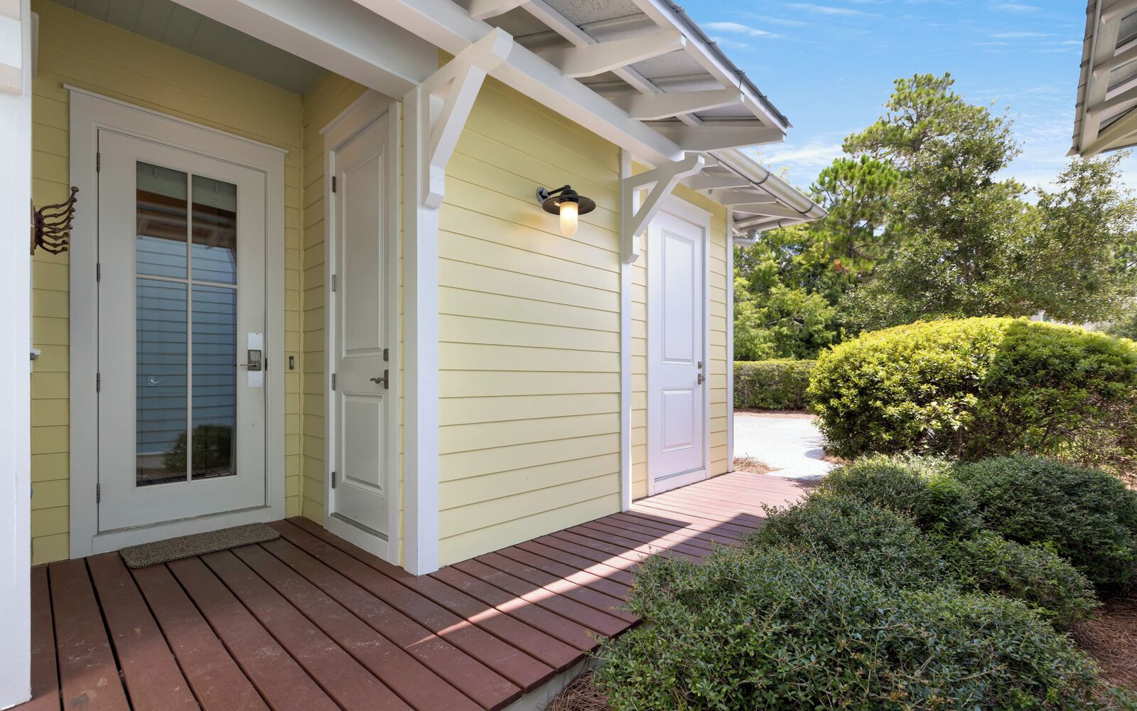 A house with a porch, a covered entryway, and a well-maintained garden.