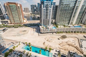 Enjoy a refreshing dip in the pool surrounded by palm trees and stunning ocean views.