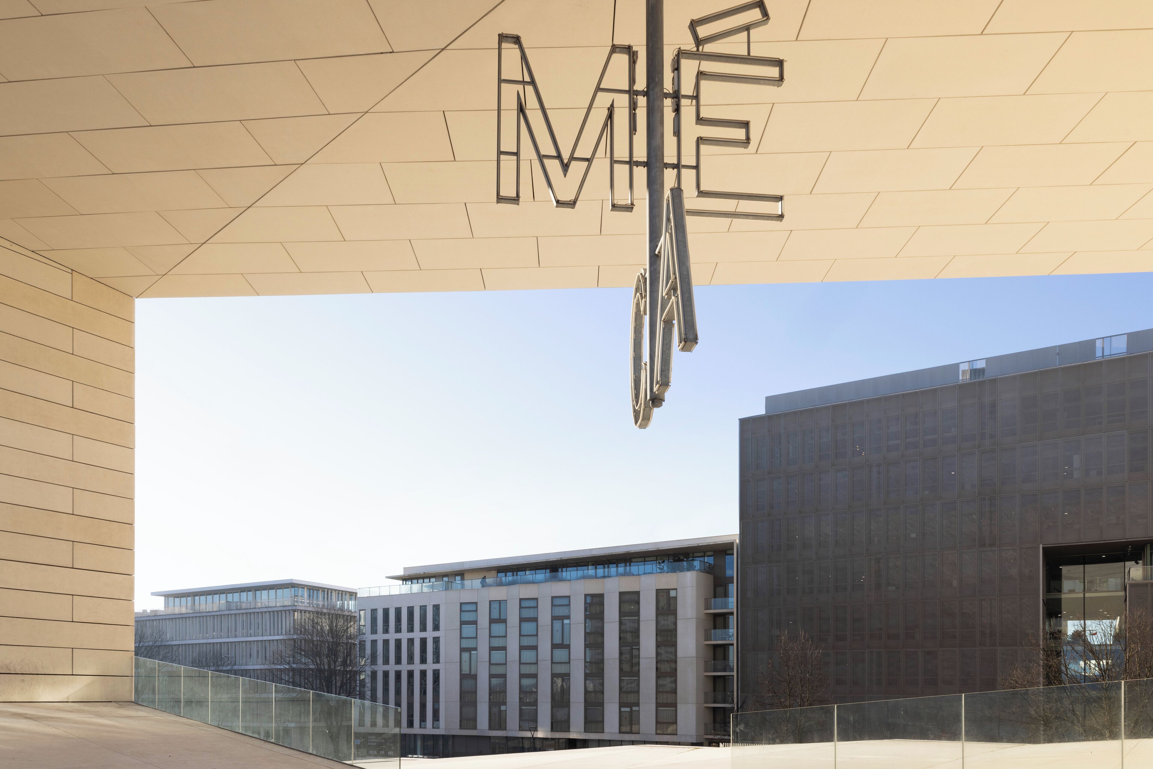 A modern building with a large, geometric sign above the entrance.