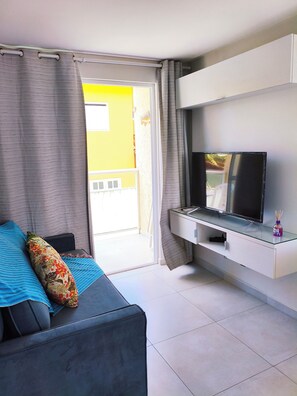 Family Studio, Partial Sea View | Living area | 50-cm Smart TV with digital channels, Netflix, streaming services