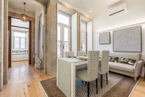 Relax in this spacious living room with a dining table and comfortable sofa.