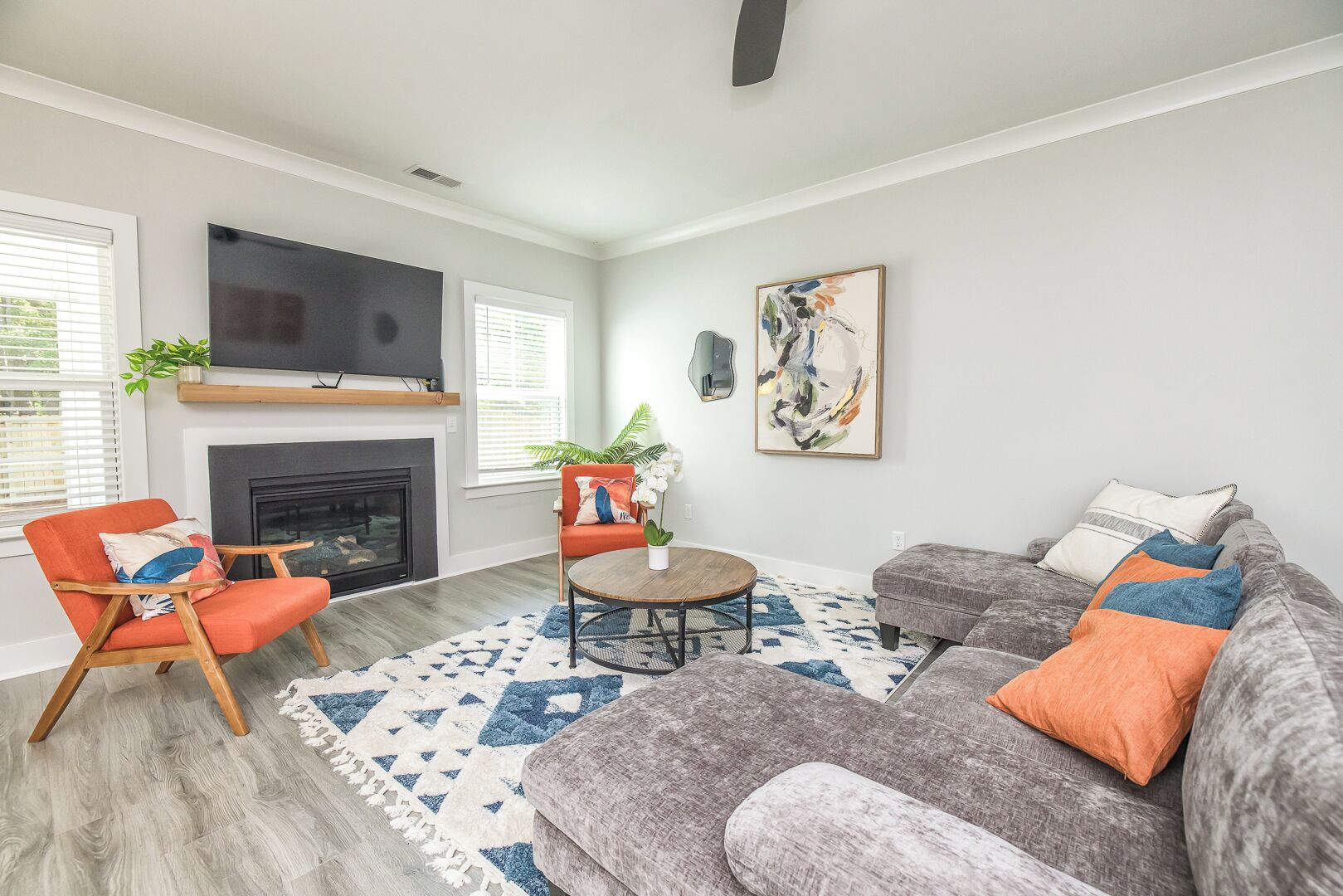 A living room with a fireplace, a television, a sofa, and a coffee table.