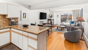 A modern apartment with a kitchen, dining area, and living room. - Gold-rated 2 Bedroom Condo at the Base of Aspen Mountain (Aspen)