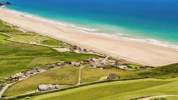 An aerial view of a coastal village with a beach, green fields, and houses. - 2 bedroom accommodation in Roch, near Haverfordwest (Roch, near Haverfordwest)