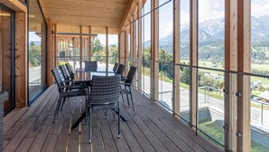 A wooden deck with a glass balustrade overlooking a mountainous landscape. - Superior Holiday Home With Sauna (Haus)