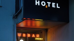 A hotel sign with "URBAN rooms" and a neon sign above the entrance. - Urban Rooms (Minsk)