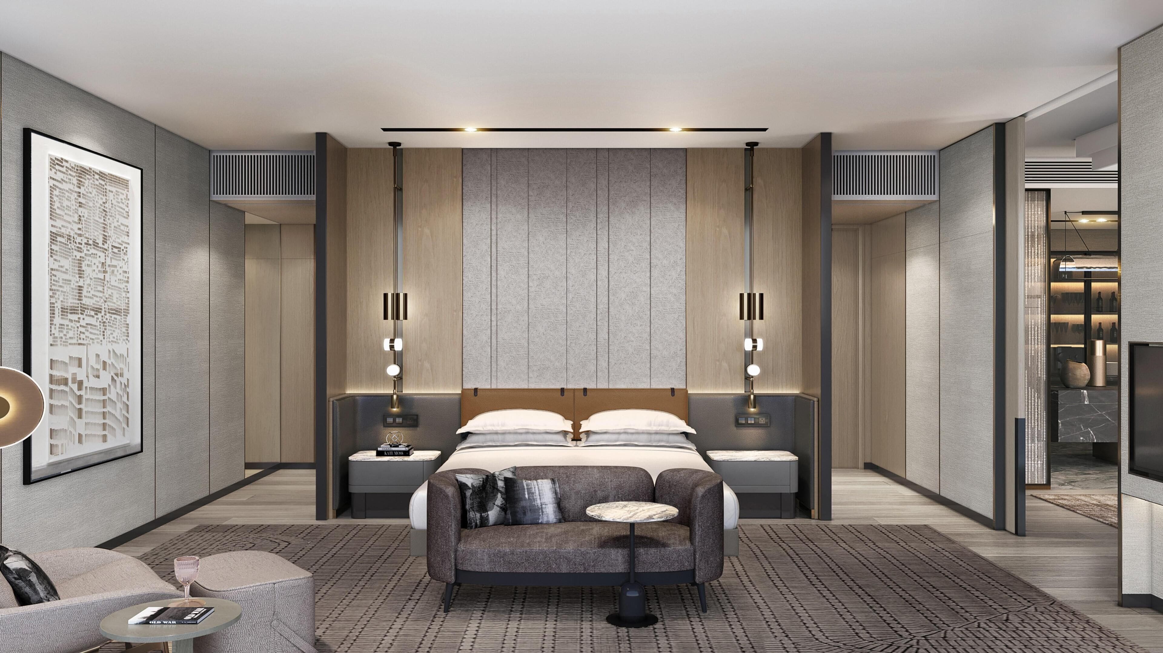 A modern hotel room with a large bed, two bedside tables, a seating area, and a minibar.