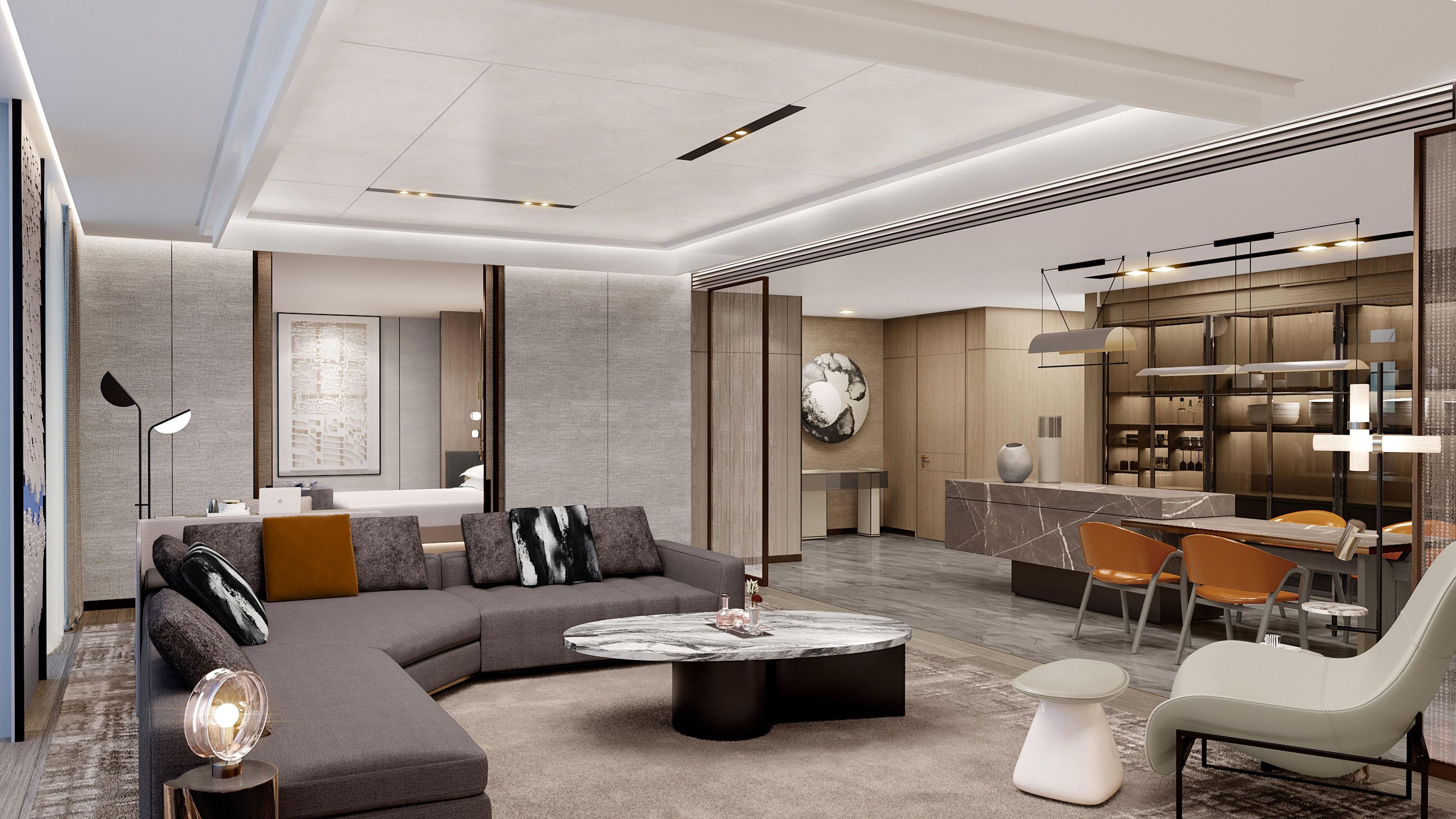 A modern living room with a sectional sofa, a round coffee table, and a dining area with a bar.