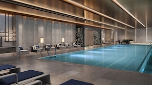A modern indoor pool area with lounge chairs, a reception desk, and a pool with clear water. - Hilton Shanghai Zhangjiang Science City (Shanghai)