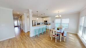 Enjoy meals in the kitchen with a central island and bar seating, featuring stainless steel appliances and pendant lighting.