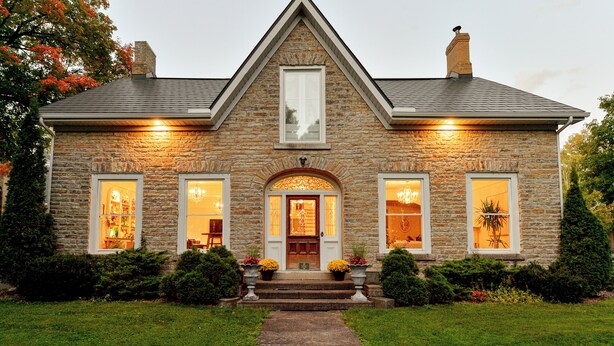A stone house with a central entrance, two side windows, and a chimney. - Nevis Estate Boutique Hotel (Perth)