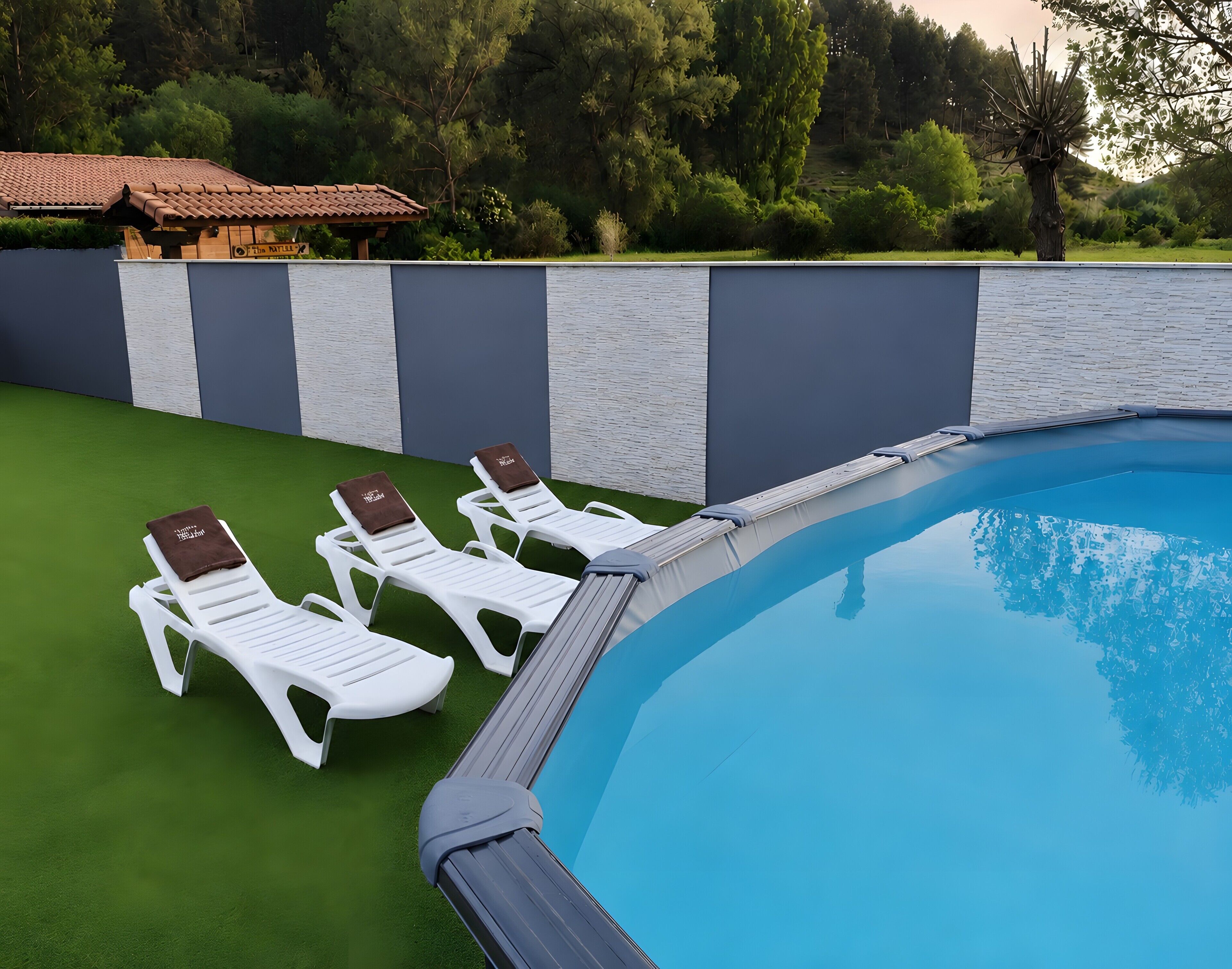 A swimming pool with white lounge chairs and a green lawn.