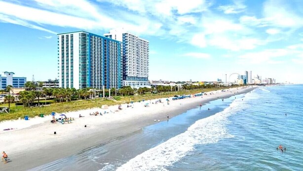 A beach with a row of high-rise buildings in the background. - Beach SPECIAL BayView Resort, 1 Bedroom Suite (Myrtle Beach)