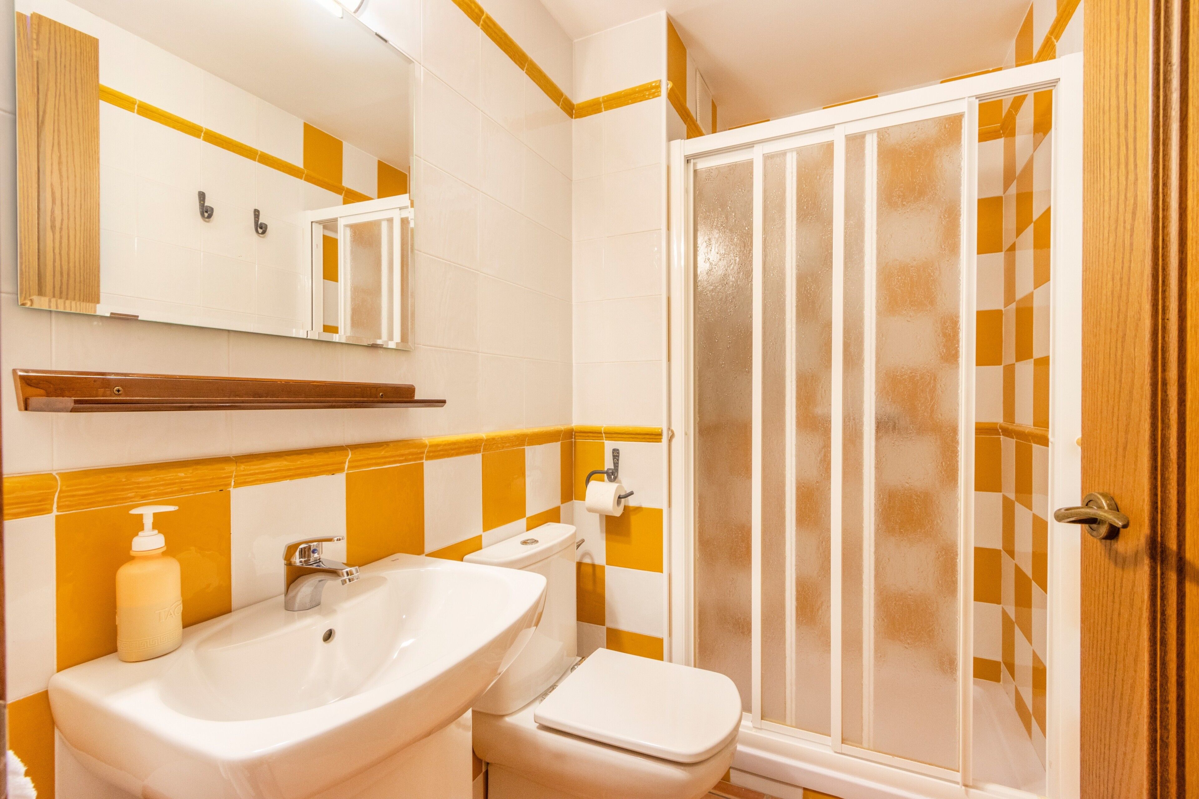 A bathroom with a sink, toilet, and shower.