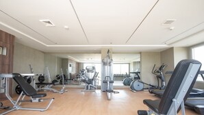A spacious gym with various exercise equipment, including treadmills, weight machines, and free weights. - Relax & unwind in this 1 BR/1 Bath Condo walking distance from Ayala Mall (Cebu City)