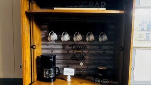 A wooden coffee station with a coffee maker, mugs, and a sign that reads "Welcome to the Coffee Nook." - 3-bedroom 2 bathroom Mobile home in delightful Union Springs with WiFi, AC (Union Springs)