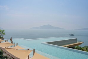 Outdoor pool, pool umbrellas, lifeguards on site