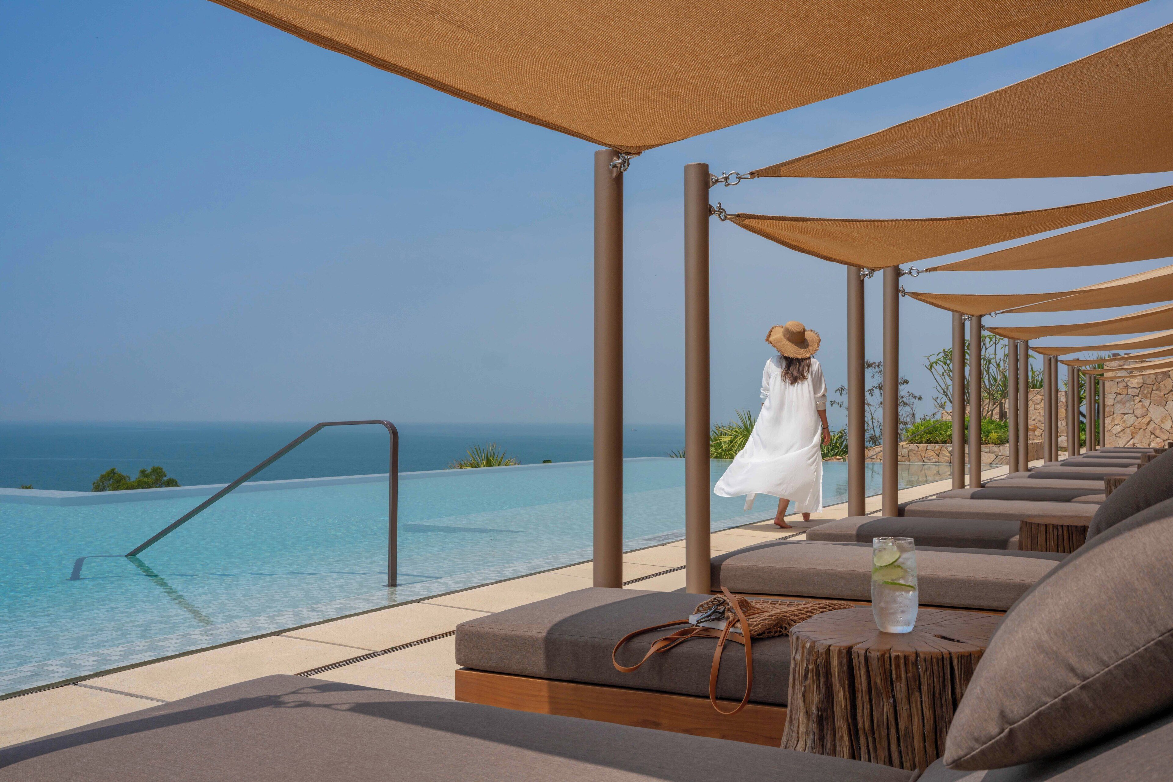 Outdoor pool, pool umbrellas, lifeguards on site