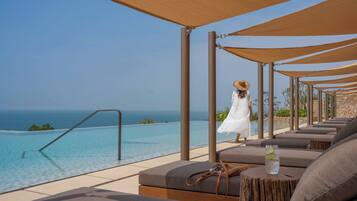 Outdoor pool, pool umbrellas, lifeguards on site