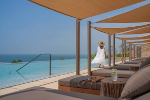 Outdoor pool, pool umbrellas, lifeguards on site
