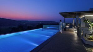 A swimming pool with a view of the landscape, a covered seating area, and a bar. - Meritas Auberge Calangute Goa (Calangute)