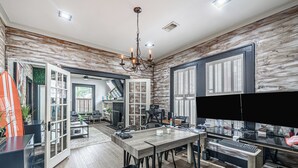 A spacious kitchen with a dining area, wooden walls, and a large window with blinds. - 3-bedroom house in delightful Houston with WiFi, fitness room, AC (Houston)