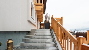 A staircase with a wooden railing leading to a building entrance. - Farmhouse in Bramberg With Sauna & Ski Access (Bramberg am Wildkogel)