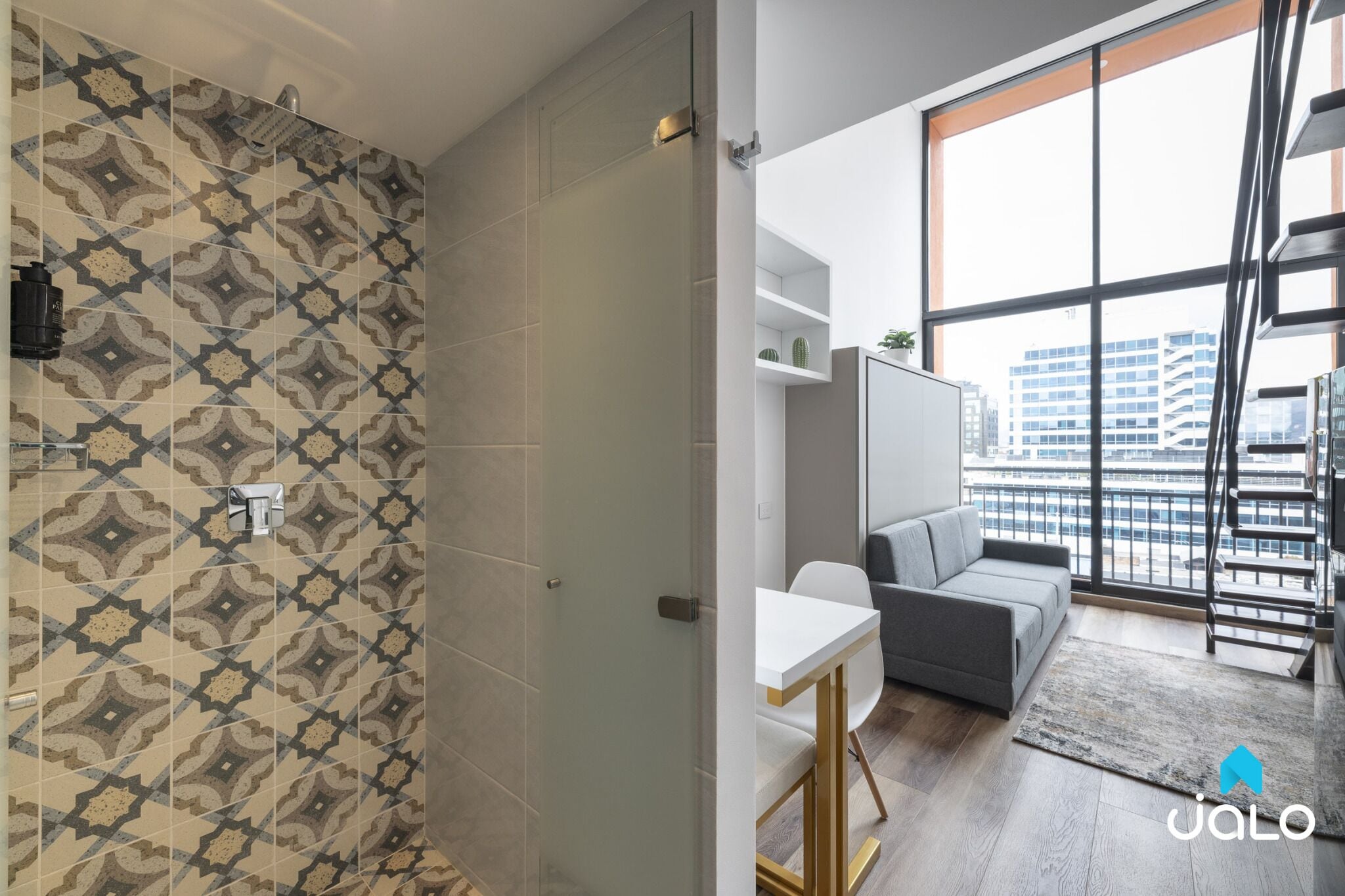 A modern apartment with patterned tiles, a white table, a gray sofa, and a large window with a city view.