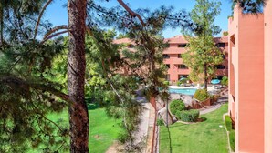 A hotel with a swimming pool, outdoor seating, and a well-maintained lawn. - Casa Rosa-4th Floor Gorgeous Condo (Phoenix, Arizona)