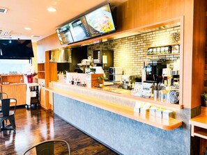 A restaurant with a counter, menu boards, and kitchen equipment. - Hotel Livemax Premium Nagano Ekimae (Nagano)
