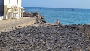 A seaside building with a sign reading "NODA". - Noda House Tarajalejo (Tarajalejo)