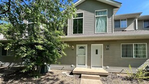 A two-story house with a front porch, a mailbox, and a number 429 sign. - North Liberty Townhouse (North Liberty)