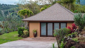 A single-story building with a tiled roof and a large window. - The Palmwood  (Kilauea)