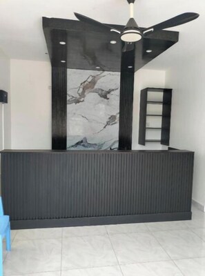 Reception area with a modern design, featuring a reception desk and abstract artwork.