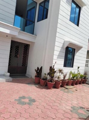 Stunning two-story building with a central entrance and beautifully landscaped frontage.