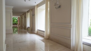 A long, well-lit hallway with a tiled floor and large windows. - Best Location & Comfort in the Walled City (Cartagena de Indias)