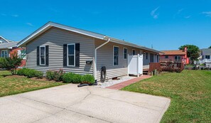 Situated in a quiet neighborhood, this single-story house features a gabled roof and a front porch.
