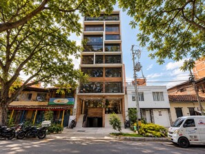 A multi-story building with a modern design, featuring large windows and a visible entrance. - Hotel ECO 44 (Medellín)