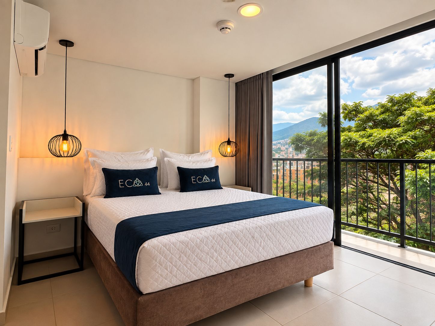 A hotel room with a bed, bedside tables, a view of the outdoors, and a balcony.