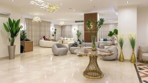 A modern living room with a marble coffee table, plush sofas, and decorative plants. - Mazar Pyramids Hotel (Giza)