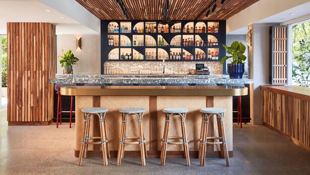 A modern bar area with a wooden ceiling, a bar counter, and four wicker stools. - 2 Double Beds with Lanai – Ideal for Families (Honolulu)