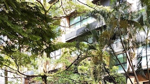 A multi-story building with a modern architectural design, featuring large windows and balconies. - Kyux by Jalo (Medellín)