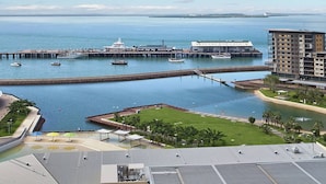 A waterfront hotel with a pier, boats, and a view of the ocean. - Zenlux 4BR Waterfront Penthouse Pad 270 Panoroma (Darwin)