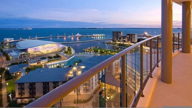 A high-rise building with a balcony overlooking a marina and cityscape. - Zenlux 4BR Waterfront Penthouse Pad 270 Panoroma (Darwin)