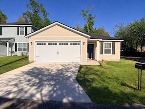 A single-story house with a garage, a front porch, and a well-maintained lawn.