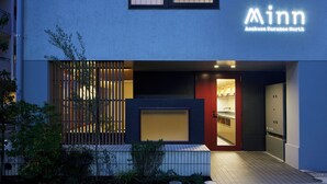 A modern building with a sign reading "Minn Asakusa Kuramase North".